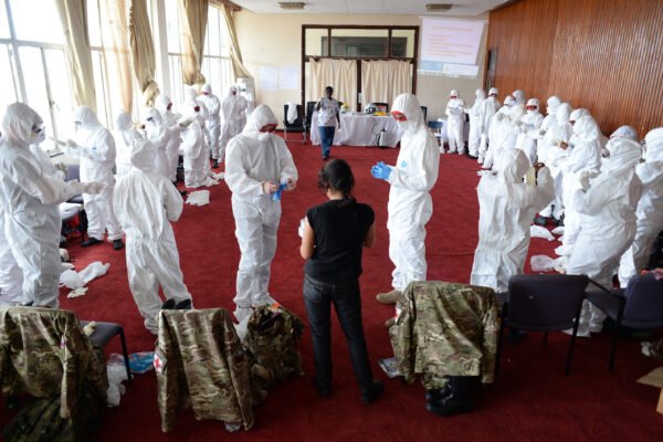 Medical personnel train in protective equipment during an Ebola response.