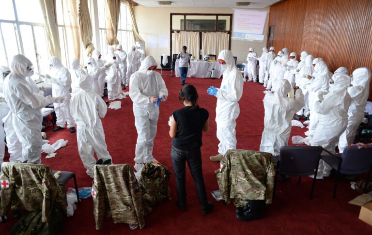 Medical personnel train in protective equipment during an Ebola response.