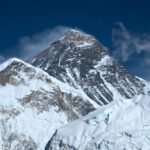 Mount Everest rising above clouds in the Himalayas in Nepal.