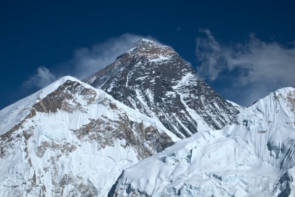 Mount Everest rising above clouds in the Himalayas in Nepal.