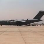 Afghan evacuees boarding a US military transport aircraft at Kabul airport during the 2021 evacuation.