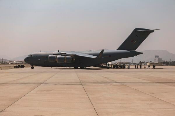 Afghan evacuees boarding a US military transport aircraft at Kabul airport during the 2021 evacuation.