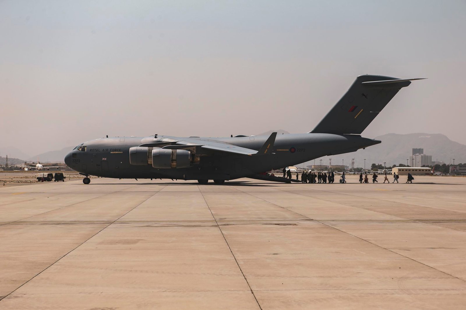 Afghan evacuees boarding a US military transport aircraft at Kabul airport during the 2021 evacuation.