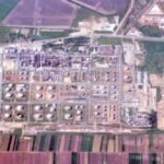 An oil refinery with processing towers and storage tanks