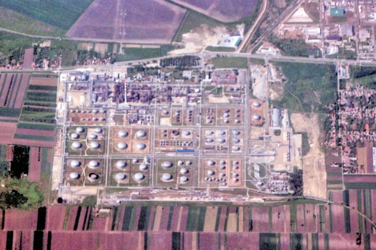An oil refinery with processing towers and storage tanks