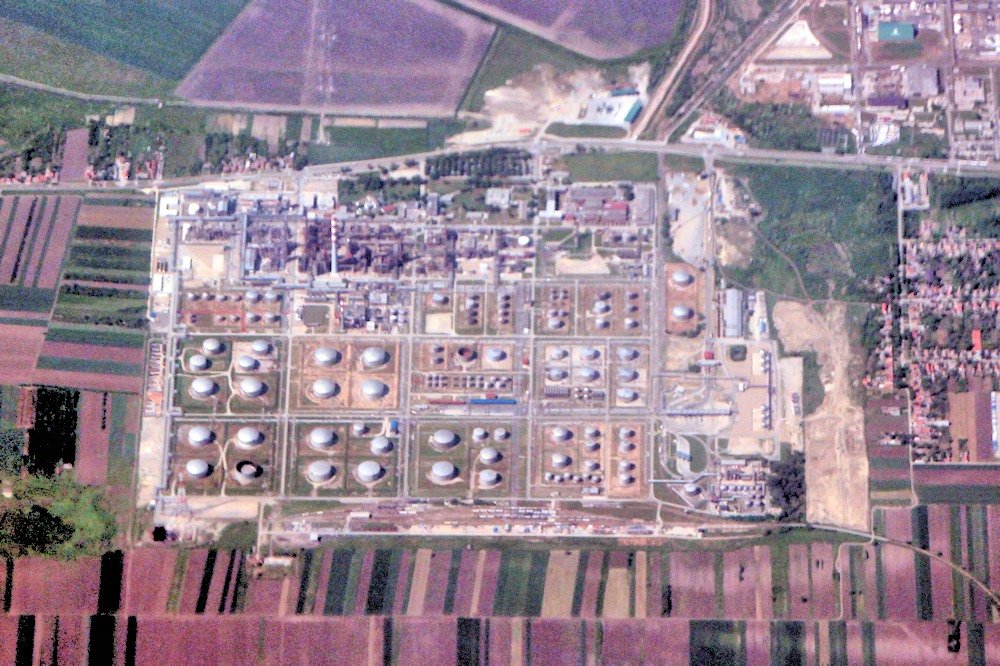 An oil refinery with processing towers and storage tanks